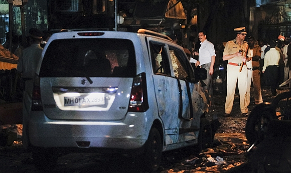 A policeman stands at the site of an explosion near the Opera House in Mumbai during the 13/7 blasts