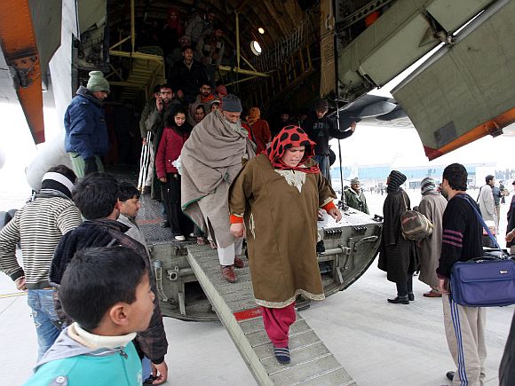 Rescued civilians disembark from the IAF's AN-32 relief aircraft
