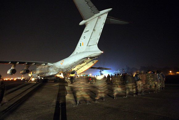 Army personnel boarding the IL-76 transpost aircraft