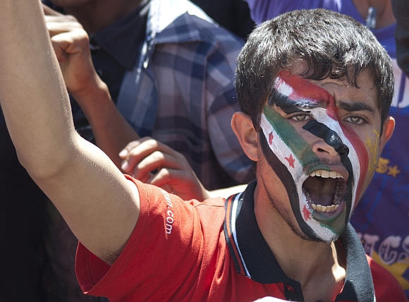 An anti-government protester shouts slogans during a rally in Sanaa