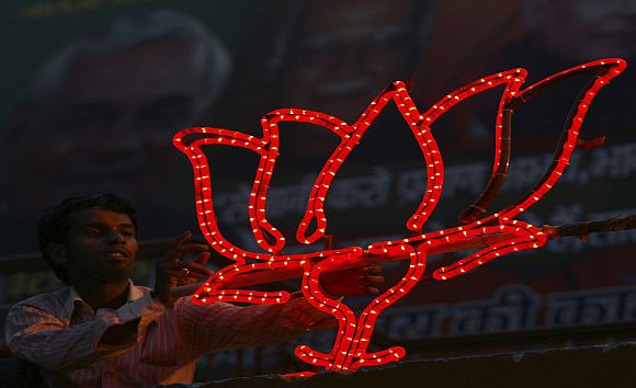 A BJP worker installs his party's symbol at the party office in Lucknow