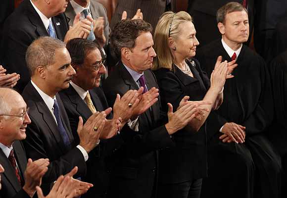 (Left to right) Interior Secretary Ken Salazar, Attorney General Eric Holder, Defence Secretary Leon Panetta, Treasury Secretary Timothy Geithner and Secretary of State Hillary Clinton applaud as Supreme Court Chief Justice John Roberts looks on as U.S. President Barack Obama delivers his State of the Union address