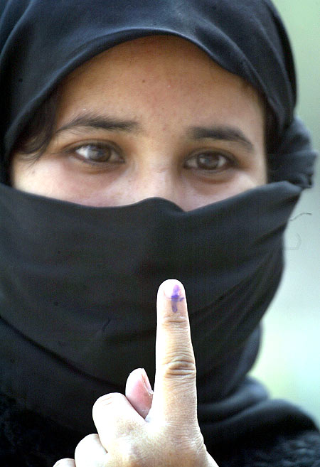 A woman shows the indelible ink mark after casting her vote in Lucknow in the 2009 Lok Sabha election