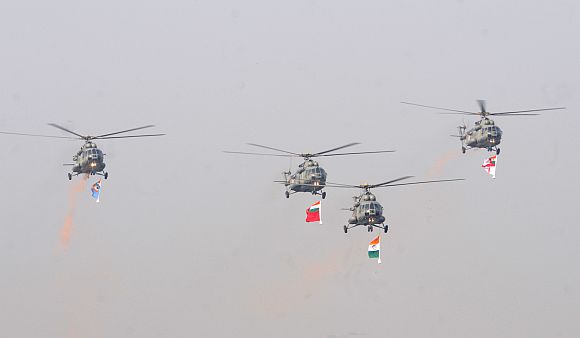 IAF Helicopters carrying the tricolour and three services flag