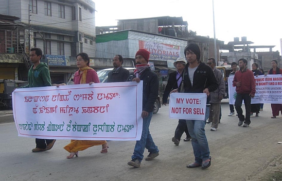 Activists of a peoples' rights group in Imphal with their banner