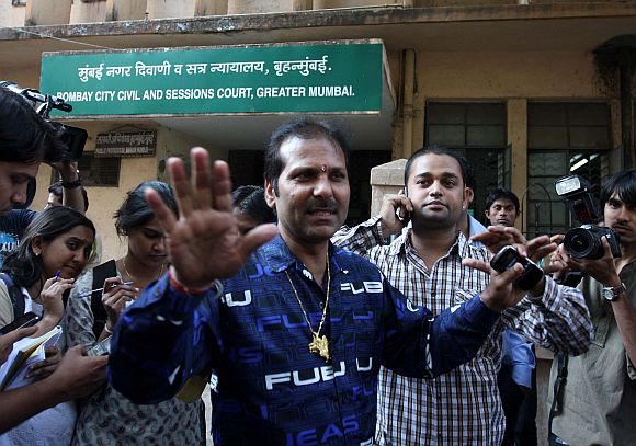 Accused Ayush Bhat's father Arun Bhat (in blue shirt) and Yash Bhat (in green shirt) speaking to mediapersons outside the sessions court in Mumbai on Monday
