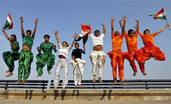 College students dressed in the colours of India's national flag rehearse for the Republic Day parade