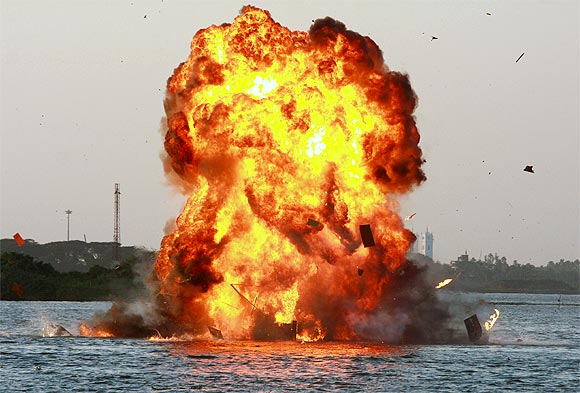 Marine Commandos display the execution of a sabotage operation on a simulated oil rig during the Indian Navy's demonstration of operational capabilities