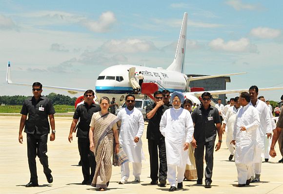 PM Singh with Congress chief Sonia Gandhi and Assam CM Tarun Gogoi at the Guwahati airport after surveying the flood affected districts on Monday