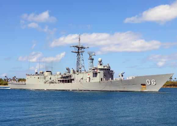 The Royal Australian Navy Adelaide-class guided-missile frigate HMAS Newcastle pulls into Joint Base Pearl Harbor-Hickam, Hawaii, to support Rim of the Pacific exercises
