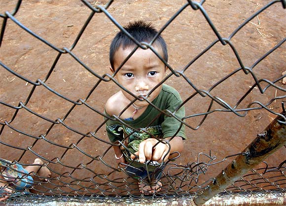 A refugee from Laos stands in Ban Huay Nam Khao camp in Phetchabun province, about 416 km northeast of Bangkok
