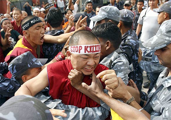 Police arrest a protesting monk outside the Chinese Embassy Visa Section in Kathmandu