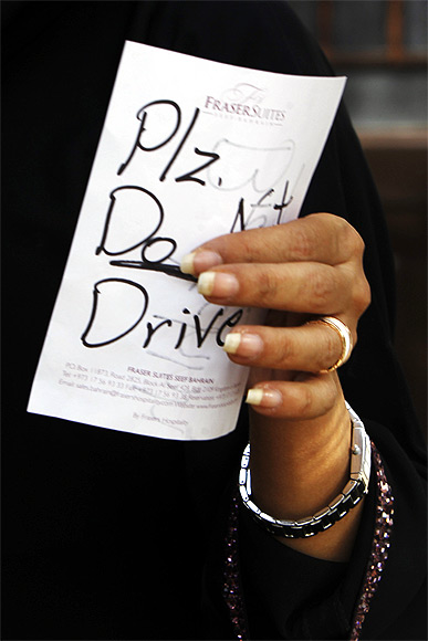 Female driver Azza Al Shmasani holds a note, which according to her, was placed on her car by an unknown person, in Saudi Arabia