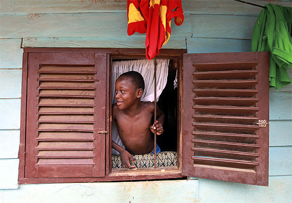 A boy looks through a window in Malabo, the capital of Equatorial Guinea