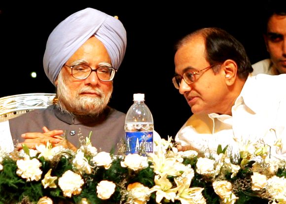PM Singh and Home Minister P Chidambaram speak during a function in New Delhi
