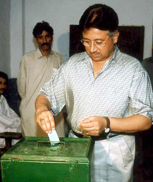 Former Pakistan President General Pervez Musharraf casts his ballot at a national park road polling station in Rawalpindi October 10, 2002