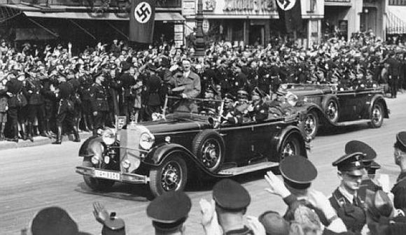 Hitler is seen riding on one the cars in his Mercedes fleet in this undated photo
