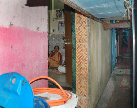 Tushar's mother inside her house as seen from the passageway