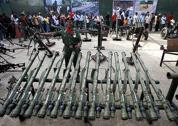 A solider describes a display of weapons captured from the Liberation Tigers of Tamil Eelam in Colombo
