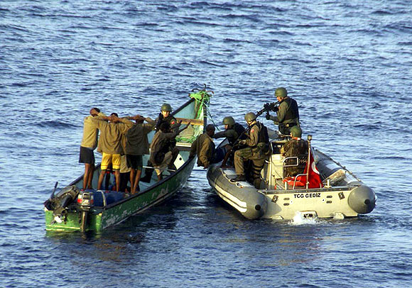 Marines from NATO's Turkish frigate Gediz arrest suspected pirates on their skiff in the Gulf of Aden September 26, 2009