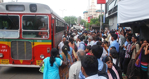 People clamour for space at a bus stand in Mumbai