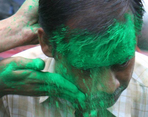 Congress supporters celebrate by applying 'abeer' on each others' faces in Kolkata on Sunday