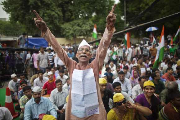 A supporter of Hazare shouts slogans as he takes part in a protest in New Delhi