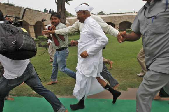 Anna Hazare runs from his supporters after paying respects at the Mahatma Gandhi memorial at Rajghat, ahead of his protest against corruption in New Delhi July 25