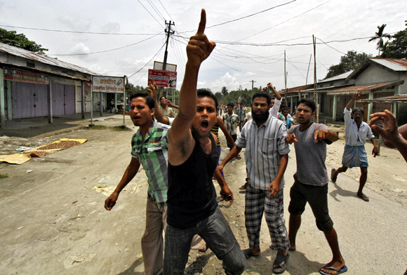 Villagers affected by the ethnic riots demonstrate against the visit of Assam legislators at a relief camp in Bijni town