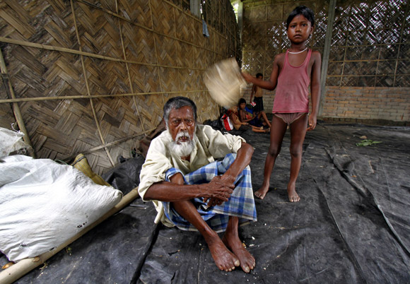 Jahar, a villager affected by the ethnic riots, at a relief camp near Bijni town, as his granddaughter fans him