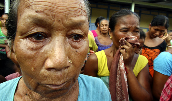 Women, whose homes were burnt down, weep at a relief camp in Goshaigaon town