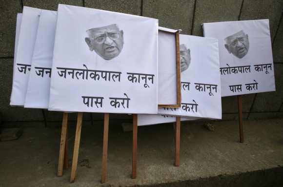 Placards are seen on a sidewalk during a campaign in support of a controversial anti-corruption bill in New Delhi