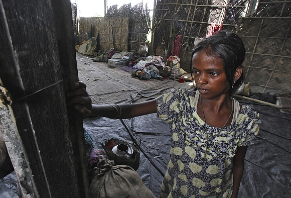 A girl affected by ethnic riots is seen inside a relief camp near Bijni in Assam