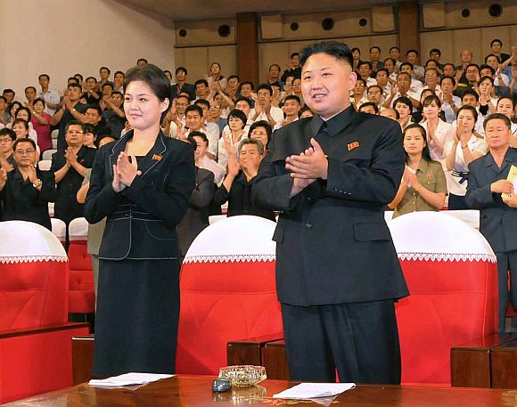 North Korean leader Kim Jong-Un applauds with his wife Ri Sol-Ju during a demonstration performance by the newly formed Moranbong band in Pyongyang