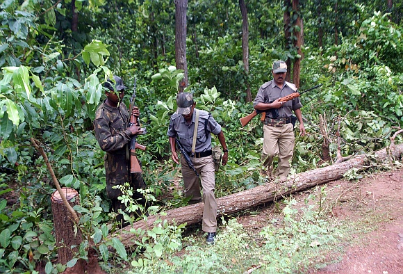 Paramilitary police forces check the blast area inside a forest at Lalgarh, about 200km west of Kolkata