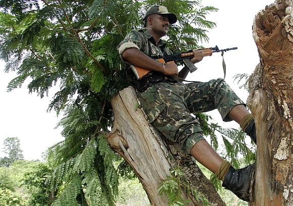 A paramilitary soldier stands vigil from a tree at Jhitka near Lalgarh in the West Midnapore district, some 170 km west of Kolkata