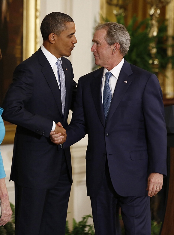 US President Barack Obama shakes hands with former US President George W Bush after Bush's official White House portrait was unveiled during a ceremony in the East Room of the White House in Washington