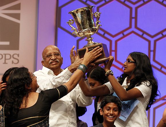 Snigdha Nandipati holds her trophy along with family members after winning the Scripps National Spelling Bee