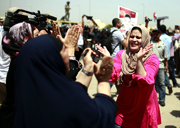 Egyptians celebrate outside the police academy where Mubarak was on trial