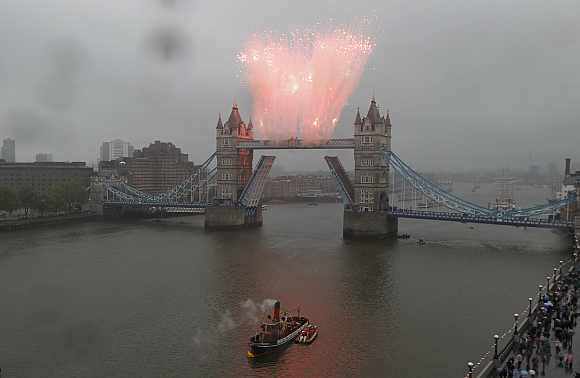 Fireworks go off on Tower Bridge to mark the end of the river pageant in London