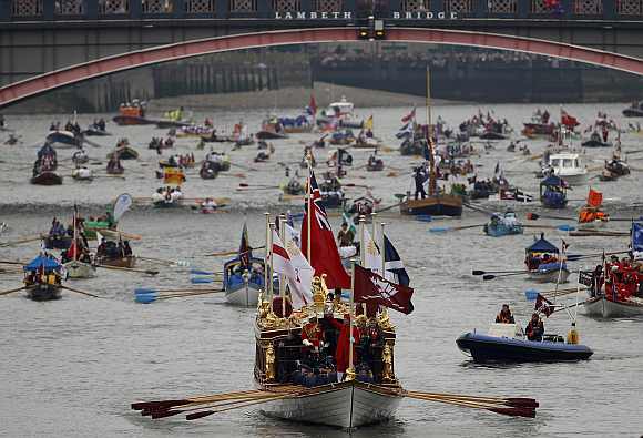 The Gloriana leads the manpowered craft towards Westminster Bridge during Queen Elizabeth