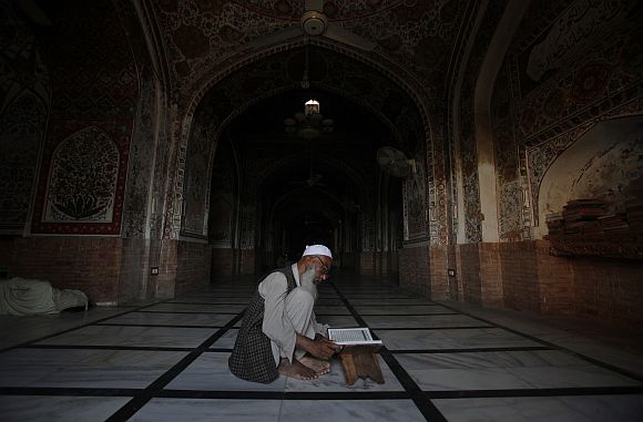 A man reads the Koran at Mahabat Khan mosque in Peshawar