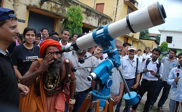 A sadhu looks at the transit of Venus through a telescope in Guwahati