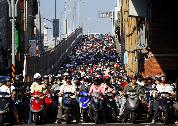 Motorists crowd at a junction during rush hour in Taipei. There are around 8.8 million motorcycles and 4.8 million cars on Taiwan's roads and nearly all motor vehicles and inhabitants are squeezed into a third of the island's area. This results in high concentrations of polluting emissions in the places where people live and work, according to official reports