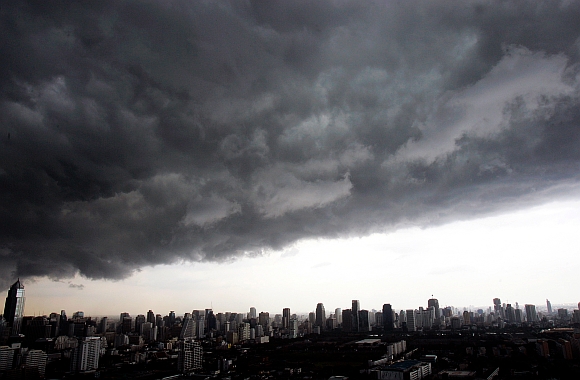 Dark rain clouds hang over Bangkok skyscrapers.The rather strong southwest monsoon prevails over the Andaman Sea and the Gulf of Thailand, which would still bring more rains and flash floods to most parts of the country, weather forecasters say