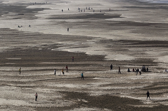 Children play cricket on the dried bed of the River Ganga in Patna