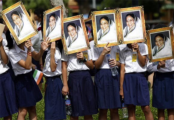 Schoolchildren hold portraits of President Pratibha Patil