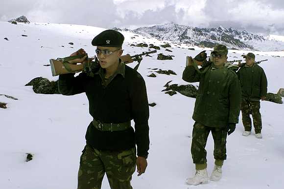 Indian soldiers patrol near the border with China in Tawang, located at a height of 11,000 feet in Arunachal Pradesh
