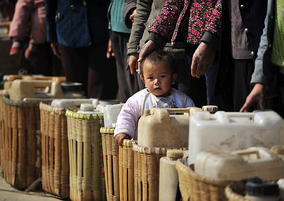 Residents wait to get drinking water distributed by the local government at a drought-hit village in Fuyuan, Yunnan province of China.