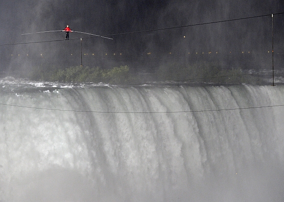 Tightrope walker Nik Wallenda walks the high wire from the US side to the Canadian side over the Horseshoe Falls in Niagara Falls, Ontario